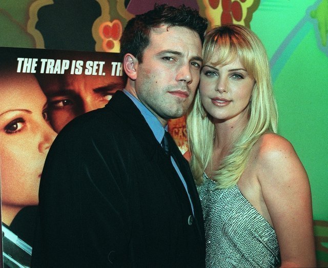 HOLLYWOOD, UNITED STATES: US actor Ben Affleck (L) poses with co-star Charlize Theron (R) as they enter the premiere of their new film 
