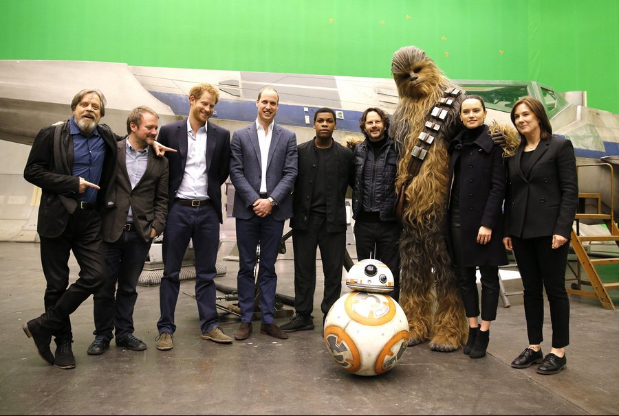epa05267213 (L-R) US actor Mark Hamill, US director Rian Johnson, Britain's Prince Harry, Britain's Prince William, Duke of Cambridge, British actor John Boyega, Chewbacca and British actress Daisy Ridley pose during a tour of the Star Wars sets at Pinewood studios in Iver Heath, west of London on April 19, 2016. Prince William and Prince Harry are touring Pinewood to visit the production workshops and meet the creative teams working behind the scenes on the Star Wars films. EPA/STR UK OUT