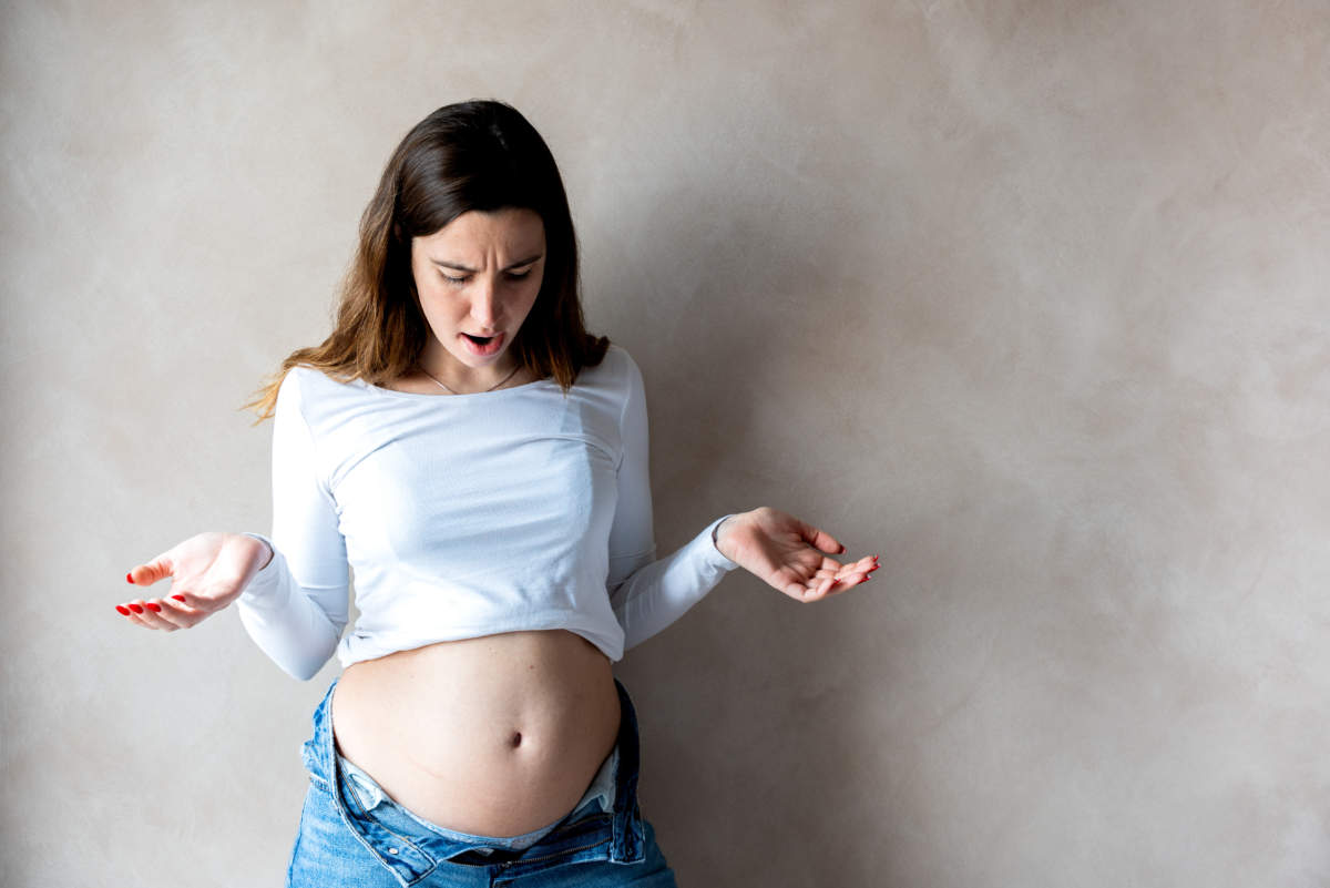 Woman With A Bloated Belly Due To Indigestion Or Pregnancy