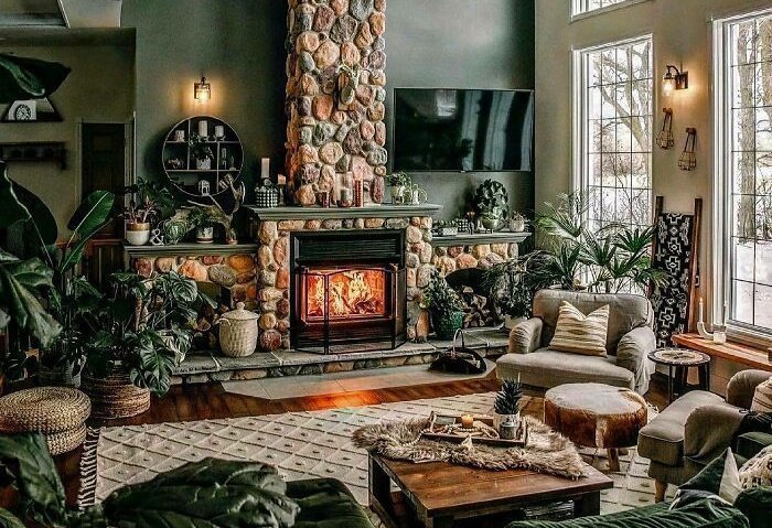 Double Height Sage Green Living Room Featuring A Stone Fireplace And Lots Of Plants, Winnipeg, Canada