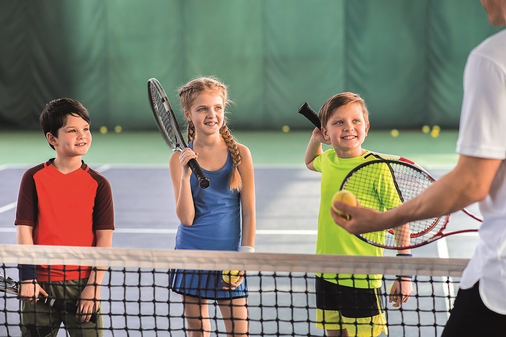 Joyful,pupils,learning,to,play,tennis