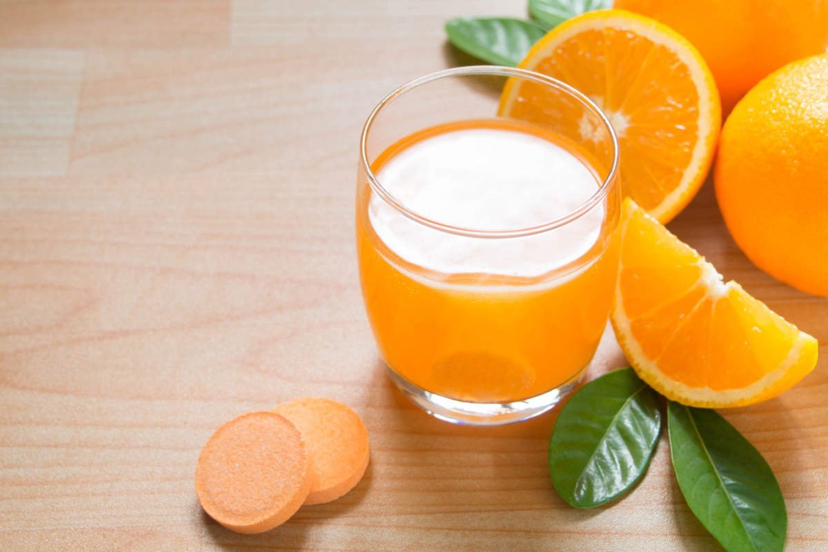 Vitamin C Effervescent Tablet Is Dissolving In Glass Of Water W/