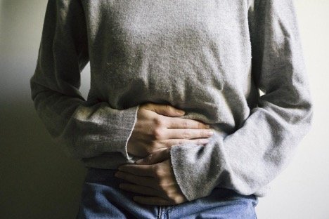 Woman Losing Weight Due To Digestive Disorders Is Holding Her Stomach 