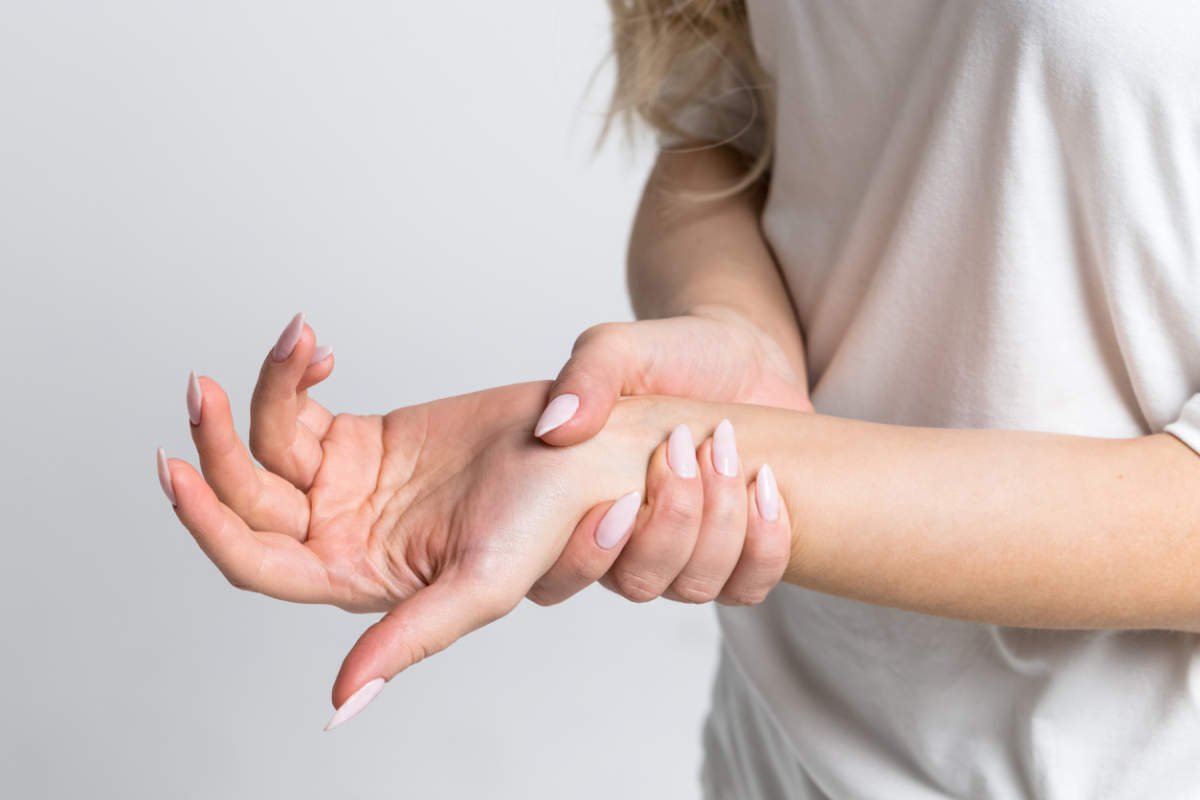 Woman Holding Her Painful Wrist After Work On Computer, Laptop. Carpal Tunnel Syndrome, Arthritis