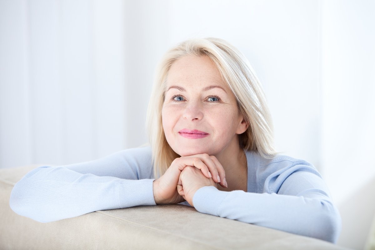 Active Beautiful Middle Aged Woman Smiling Friendly And Looking In Camera. Woman's Face Closeup. Realistic Images Without Retouching With Their Own Imperfections. Selective Focus.