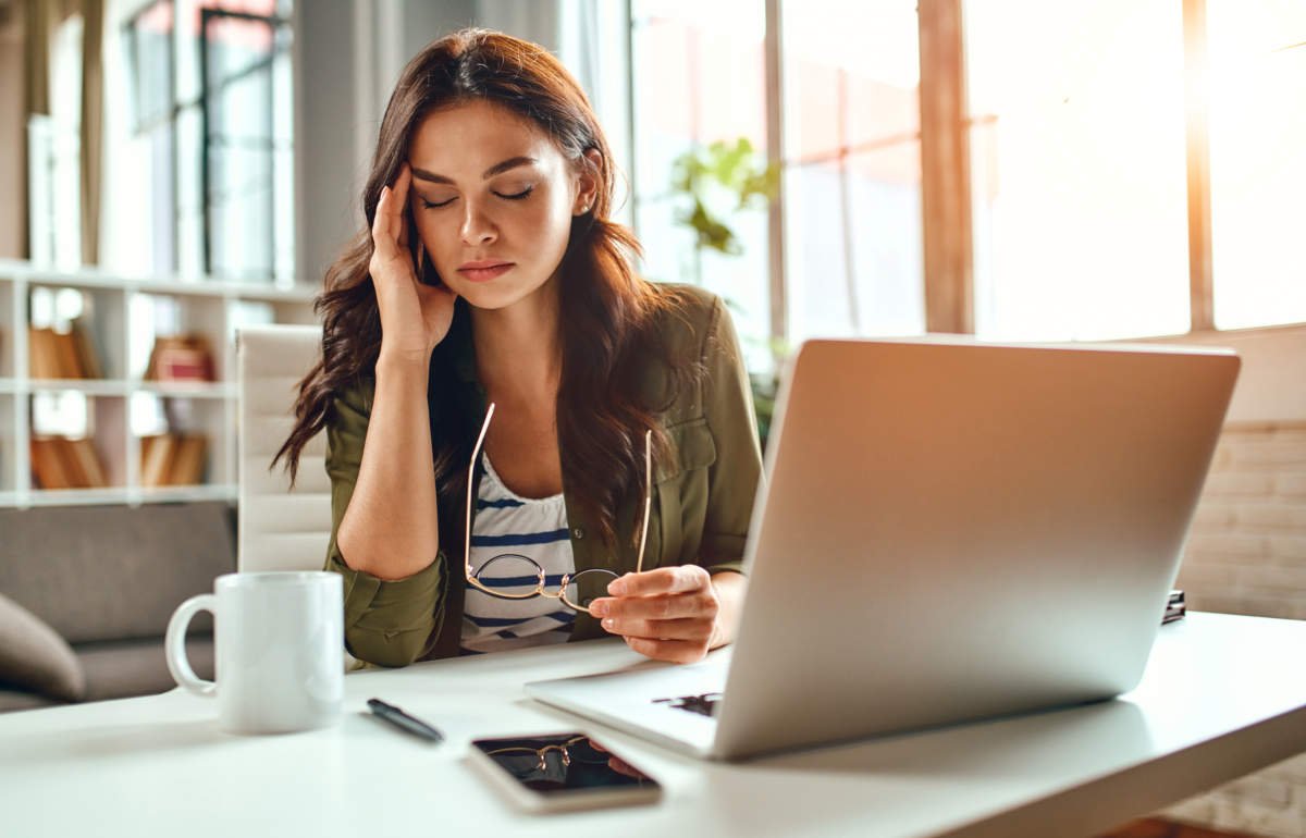 Tired Business Woman In Stress Works At A Laptop While Sitting A