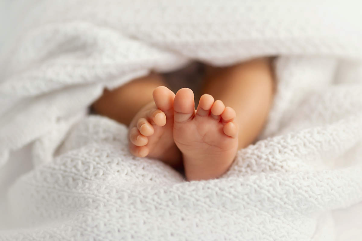 Adorable Baby Feet Covered In A White Blanket, Maternity And Bab