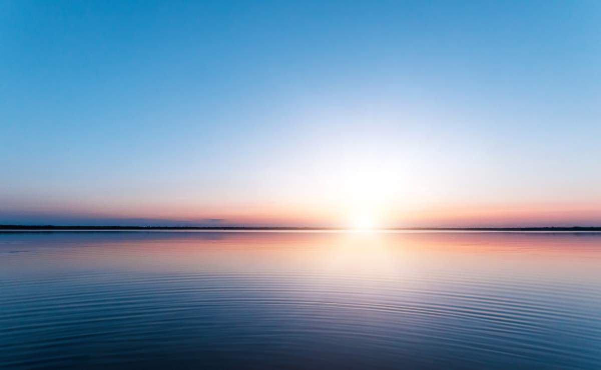 Beautiful, Red Dawn On The Lake. The Rays Of The Sun Through The Fog. The Blue Sky Over The Lake, The Morning Comes, The Sky Is Reflected In The Water.