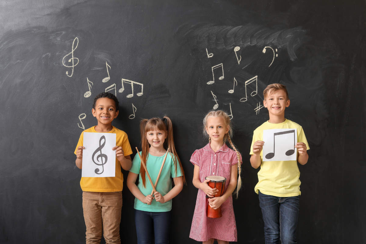 Little Children Near Chalkboard At Music School