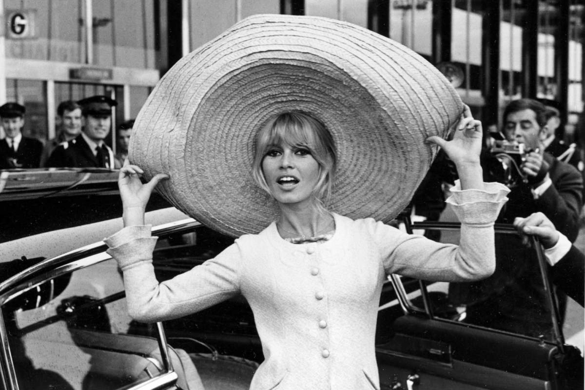 French Actress Brigitte Bardot Poses With A Huge Sombrero She Brought Back From Mexico, As She Arrives At Orly Airport In Paris, France, On May 27, 1965.
