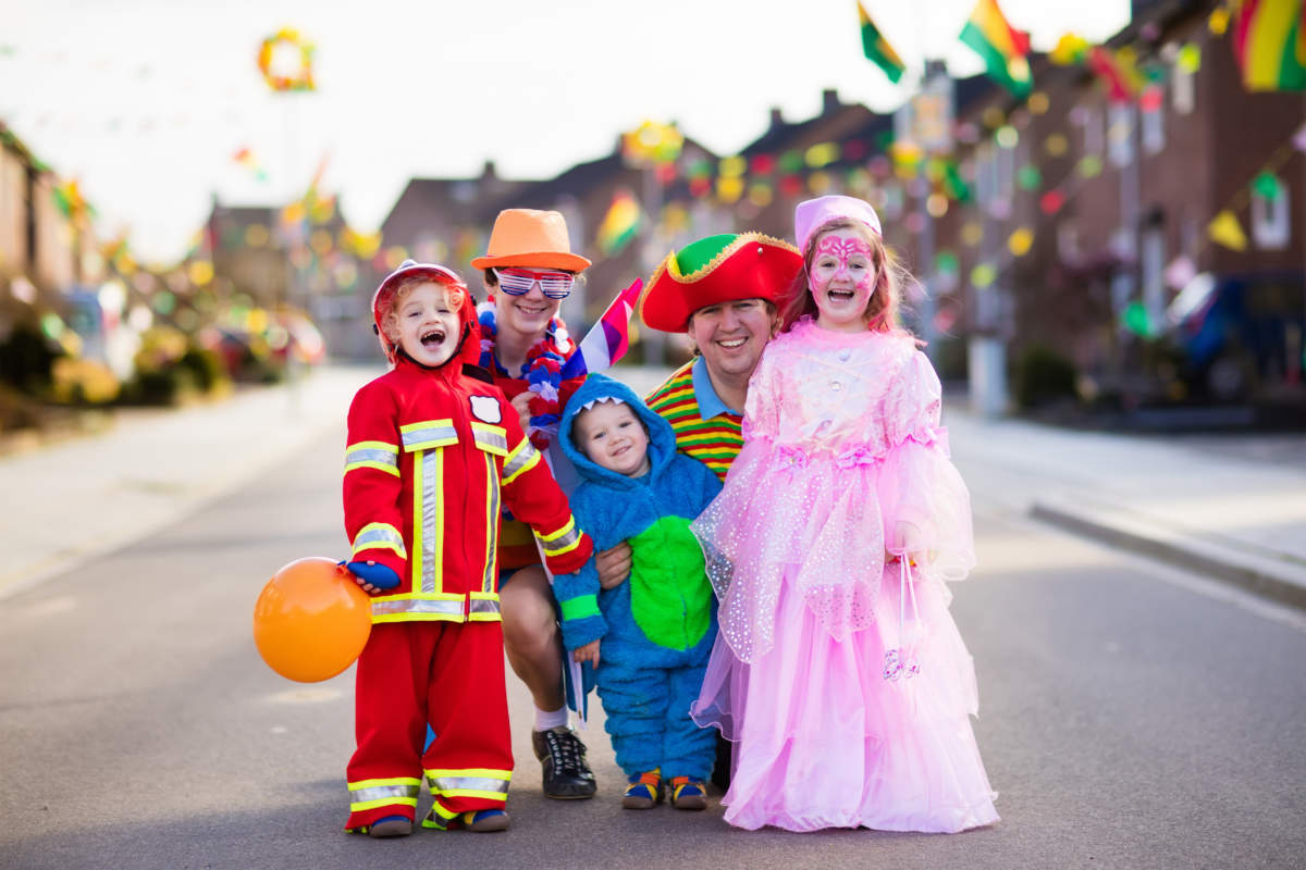 Kids And Parents On Halloween Trick Or Treat