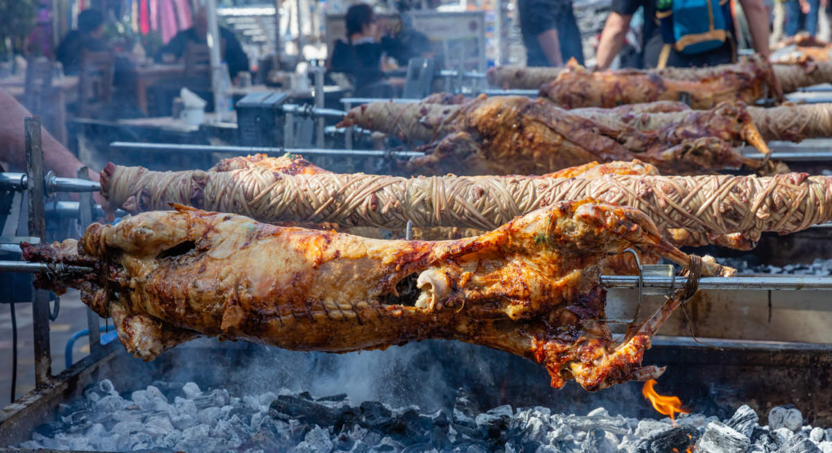 Greek Easter Custom. Kokoretsi, Kokorec And Lamb, Sheep, Kid Grilling On Spits Over Charcoals Fire.