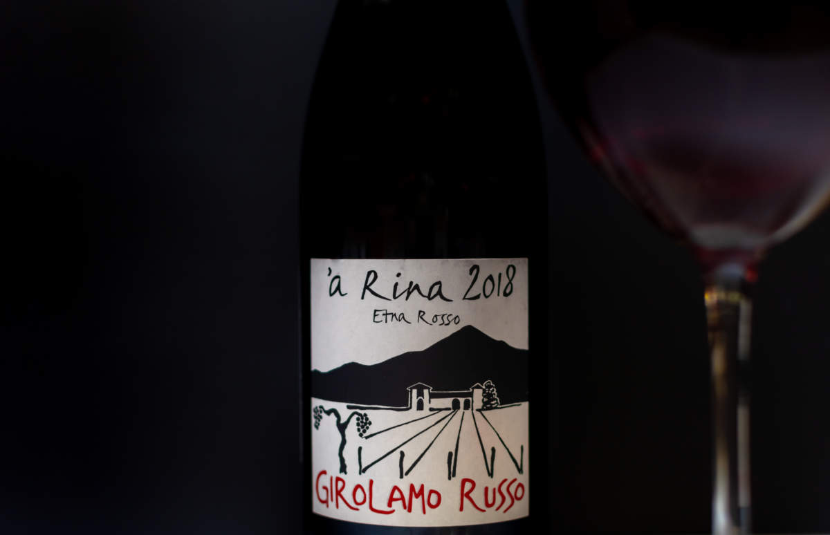 Bottle Of Italian Red Wine A Rina 2018 Etna Rosso Girolamo Russo Close Up On Black Background With Red Wine Glass. Ukraine, Zhytomyr, July, 02, 2024