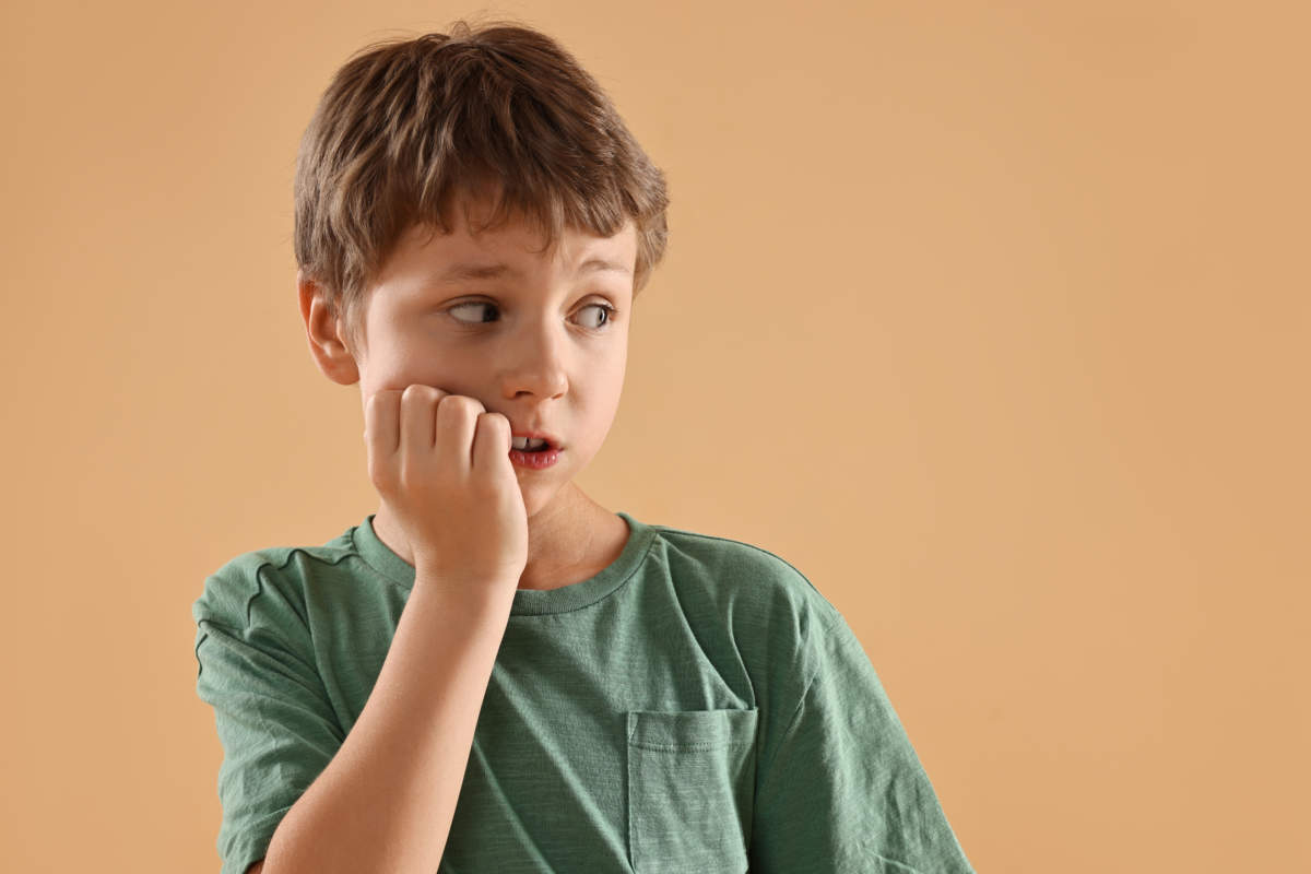 Scared Little Boy On Beige Background. Space For Text