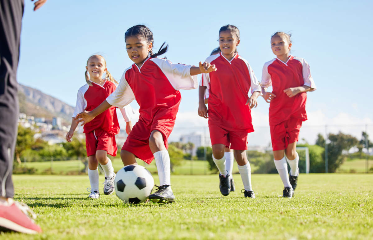 Soccer, Ball Or Sports And A Girl Team Training Or Playing Together On A Field For Practice. Fitness, Football And Grass With Kids Running Or Dribbling On A Pitch For Competition Or Exercise