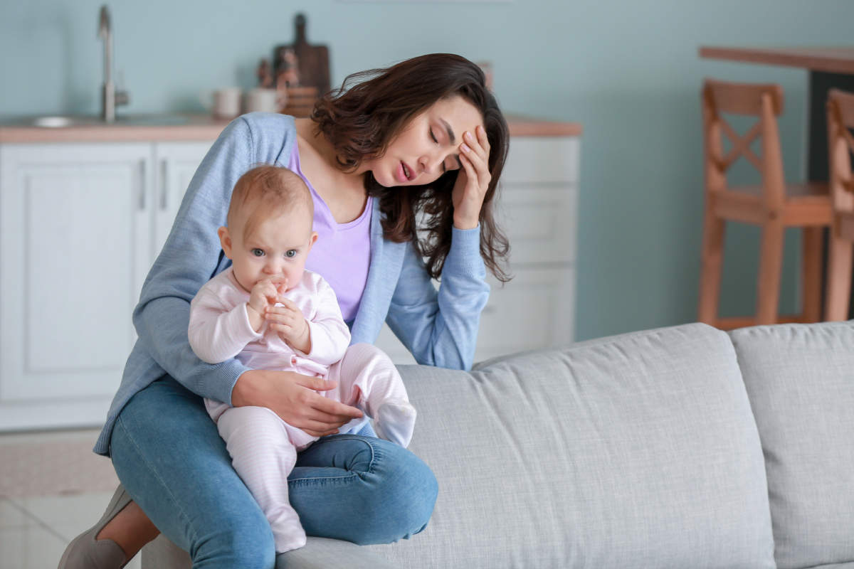 Young Woman Suffering From Postnatal Depression At Home