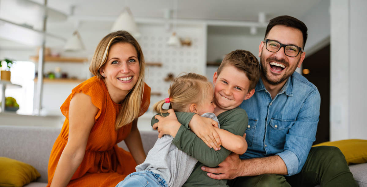 Happy Family Having Fun Time At Home. Parents Children Love Happiness Concept.