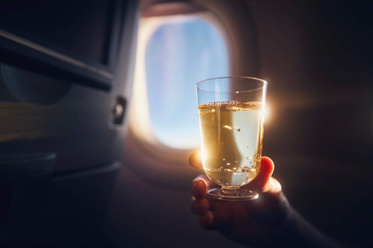 Man Enjoying Drink During Flight