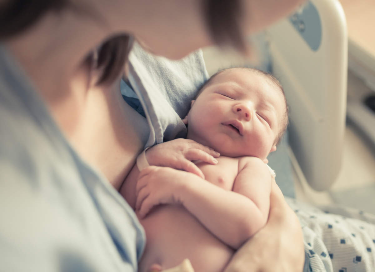 Parenting And New Life Concept. Mother Holding Newborn Baby Boy