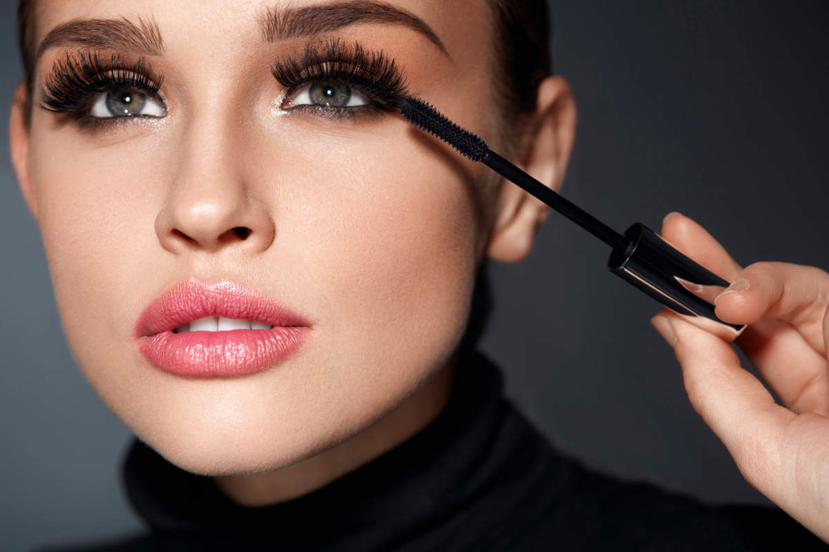 Beauty. Beautiful Woman Applying Black Mascara On Eyelashes